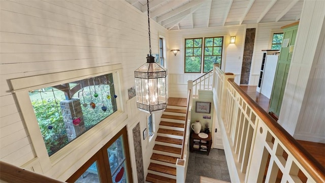 stairway with wood ceiling