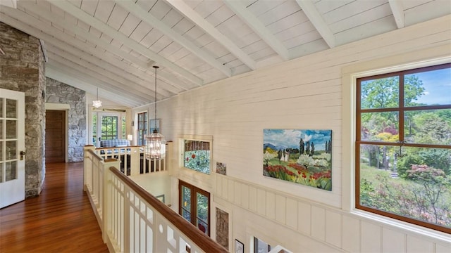 corridor featuring an upstairs landing, dark wood-style floors, a chandelier, and wood ceiling