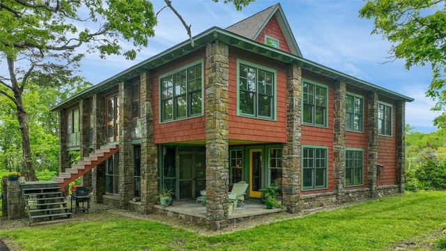 view of property exterior featuring a lawn, a patio, and stairway