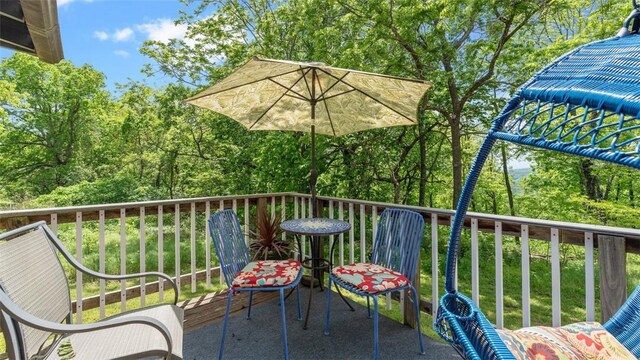deck featuring view of scattered trees