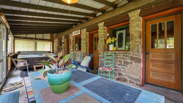 sunroom featuring beam ceiling