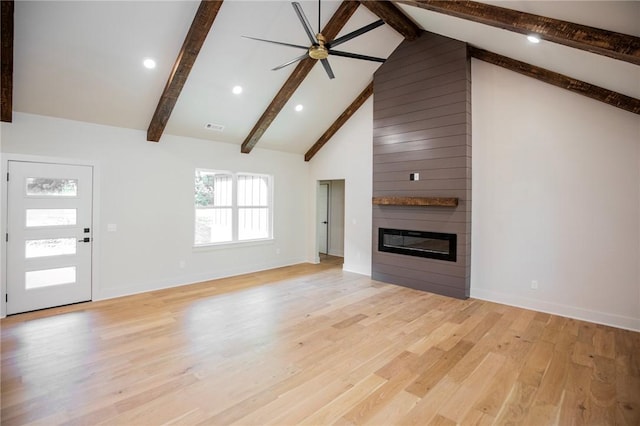 25 Lathrop Dr, Bella Vista, AR 72715 - unfurnished living room with a large fireplace, beam ceiling, light wood finished floors, ceiling fan, and baseboards