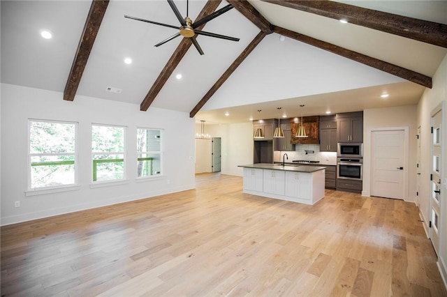 25 Lathrop Dr, Bella Vista, AR 72715 - kitchen featuring appliances with stainless steel finishes, a sink, a ceiling fan, open floor plan, and high vaulted ceiling