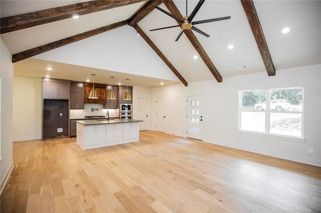 25 Lathrop Dr, Bella Vista, AR 72715 - kitchen with premium range hood, ceiling fan, a sink, high vaulted ceiling, and dark countertops