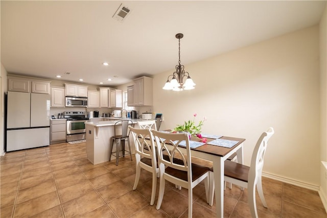 dining room with a chandelier, light tile patterned floors, and recessed lighting