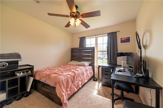 bedroom with a ceiling fan, a desk, and carpet flooring