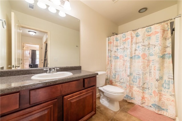 full bathroom with tile patterned flooring, toilet, vanity, and curtained shower