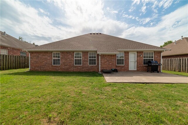 rear view of house with a patio and brick siding