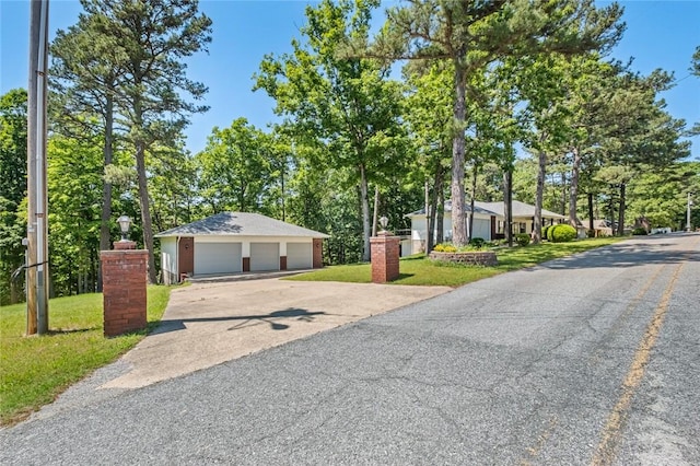 6 Rivercliff Rd, Rogers, AR 72756 - view of front of home with a garage, a front lawn, and view of wooded area