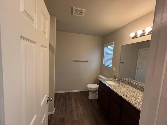811 Belhaven Rd, Centerton, AR 72719 - bathroom with wood finished floors, toilet, vanity, and baseboards