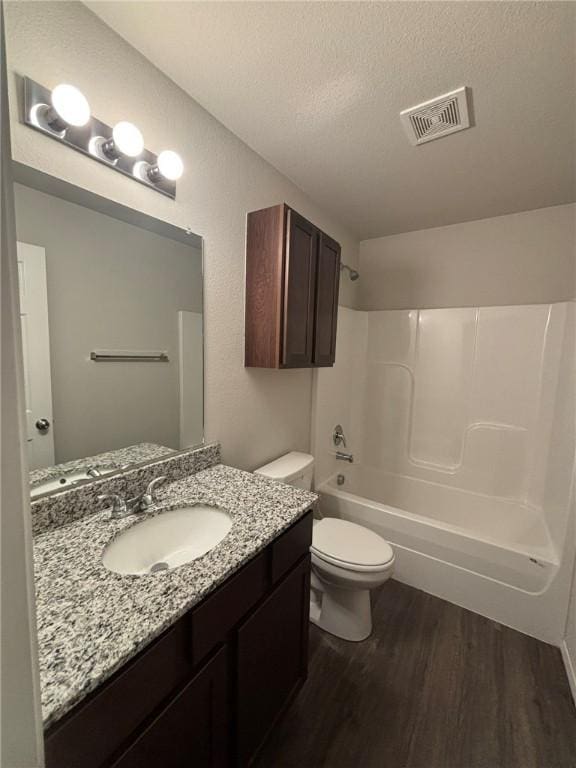 811 Belhaven Rd, Centerton, AR 72719 - full bath with wood finished floors, toilet, shower / tub combination, vanity, and a textured ceiling