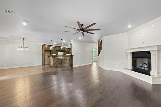 6503 S 35th St, Rogers, AR 72758 - unfurnished living room featuring ceiling fan, a fireplace with raised hearth, wood finished floors, crown molding, and baseboards