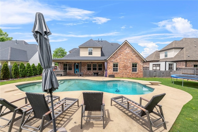 6503 S 35th St, Rogers, AR 72758 - view of pool with a patio, a covered hot tub, and a trampoline