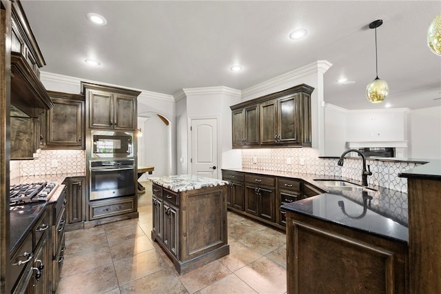 6503 S 35th St, Rogers, AR 72758 - kitchen with appliances with stainless steel finishes, a sink, dark brown cabinets, arched walkways, and tasteful backsplash