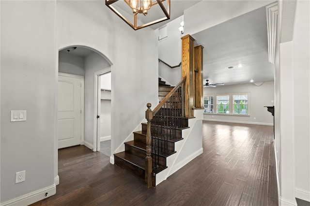 6503 S 35th St, Rogers, AR 72758 - staircase with arched walkways, wood finished floors, baseboards, and a chandelier