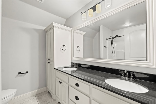 6503 S 35th St, Rogers, AR 72758 - full bath featuring baseboards, marble look tile flooring, toilet, double vanity, and a shower