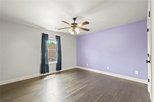 6503 S 35th St, Rogers, AR 72758 - spare room featuring a ceiling fan, dark wood finished floors, and baseboards