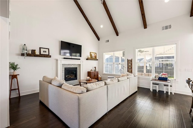 living area with baseboards, beamed ceiling, dark wood finished floors, a tile fireplace, and recessed lighting