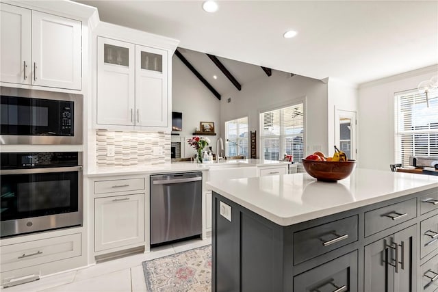 kitchen featuring stainless steel appliances, plenty of natural light, light countertops, and recessed lighting