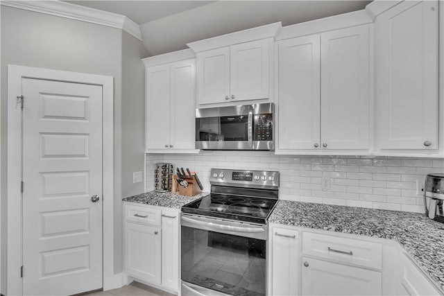 12 E Loveland Loop, Farmington, AR 72730 - kitchen with appliances with stainless steel finishes, dark stone counters, white cabinetry, tasteful backsplash, and ornamental molding