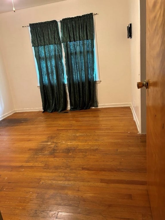 1002 N Pleasant St, Springdale, AR 72764 - unfurnished room featuring hardwood / wood-style flooring and baseboards