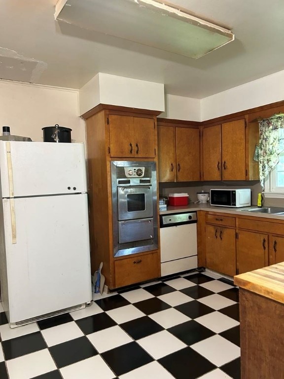1002 N Pleasant St, Springdale, AR 72764 - kitchen with white appliances, light floors, and brown cabinetry