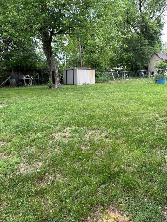 1002 N Pleasant St, Springdale, AR 72764 - view of yard with a storage unit, an outbuilding, and view of scattered trees