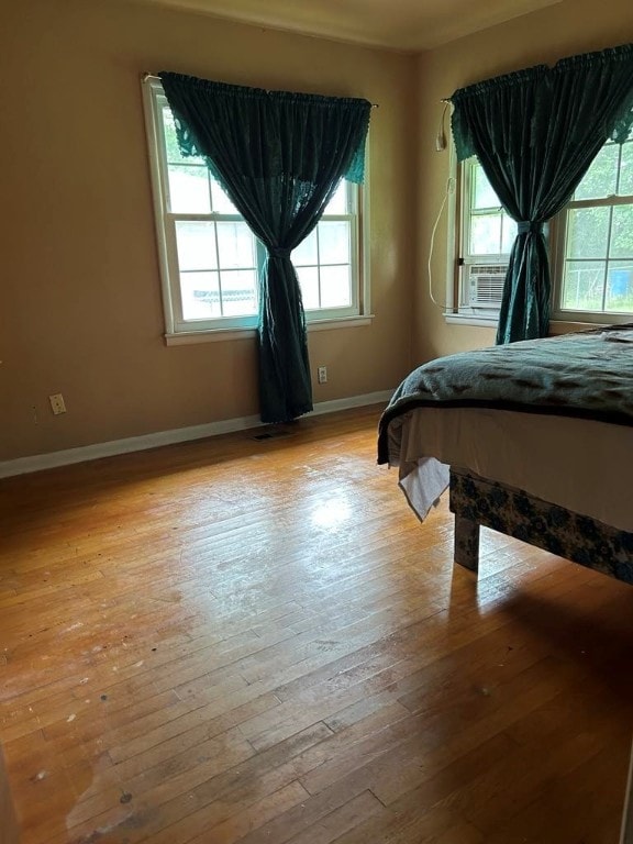 1002 N Pleasant St, Springdale, AR 72764 - bedroom with light wood finished floors, baseboards, and cooling unit