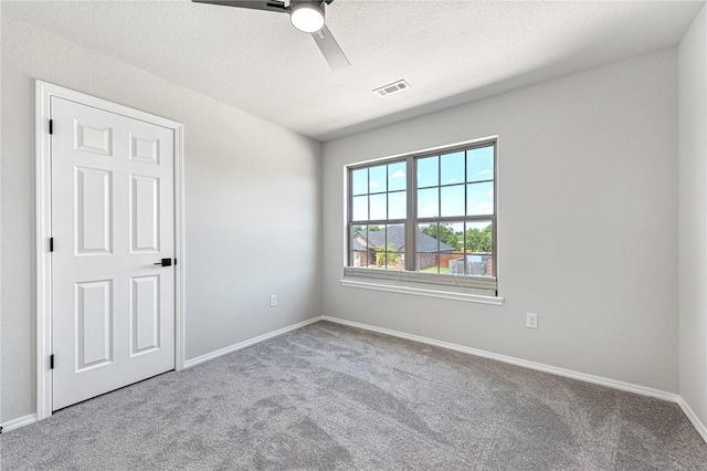1302 Walker Dr, Rogers, AR 72756 - carpeted spare room with a ceiling fan, baseboards, and a textured ceiling