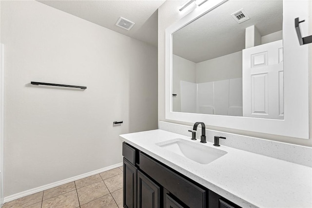 1302 Walker Dr, Rogers, AR 72756 - full bathroom with baseboards, vanity, tile patterned flooring, and a shower