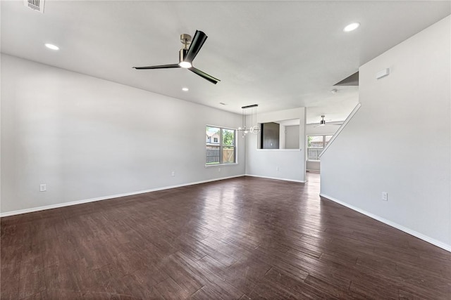 1302 Walker Dr, Rogers, AR 72756 - unfurnished living room featuring a ceiling fan, dark wood-style flooring, baseboards, recessed lighting, and a chandelier