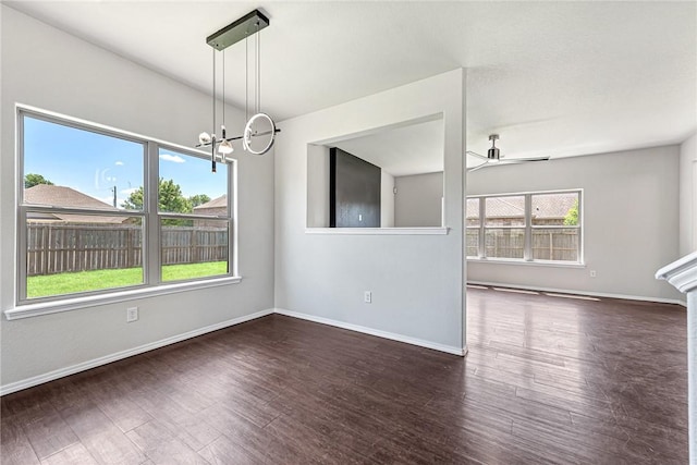 1302 Walker Dr, Rogers, AR 72756 - unfurnished dining area with wood finished floors, a ceiling fan, baseboards, and a chandelier