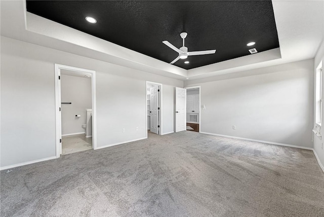 1302 Walker Dr, Rogers, AR 72756 - unfurnished bedroom featuring a raised ceiling, carpet floors, baseboards, and ensuite bath