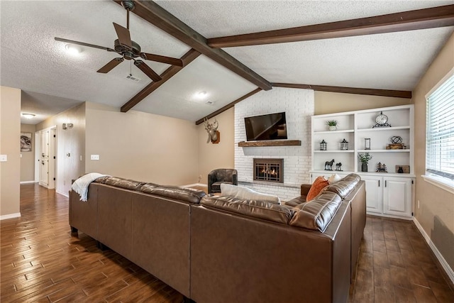 1801 Jean St, Springdale, AR 72762 - living area with dark wood-style flooring, a textured ceiling, a fireplace, and ceiling fan