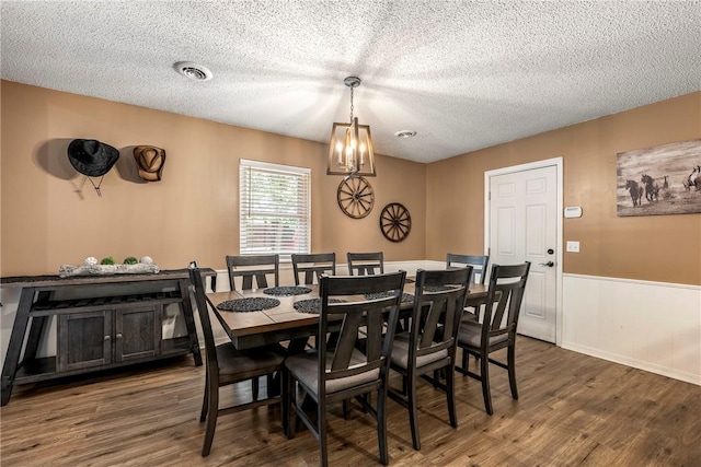 1801 Jean St, Springdale, AR 72762 - dining room featuring a chandelier, dark wood-style floors, wainscoting, and a textured ceiling