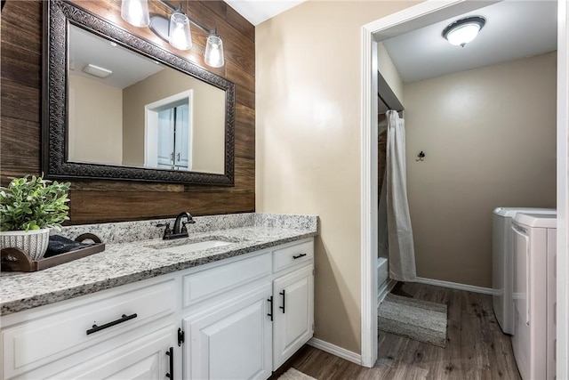 1801 Jean St, Springdale, AR 72762 - bathroom with separate washer and dryer, wood finished floors, vanity, and shower / bathtub combination with curtain