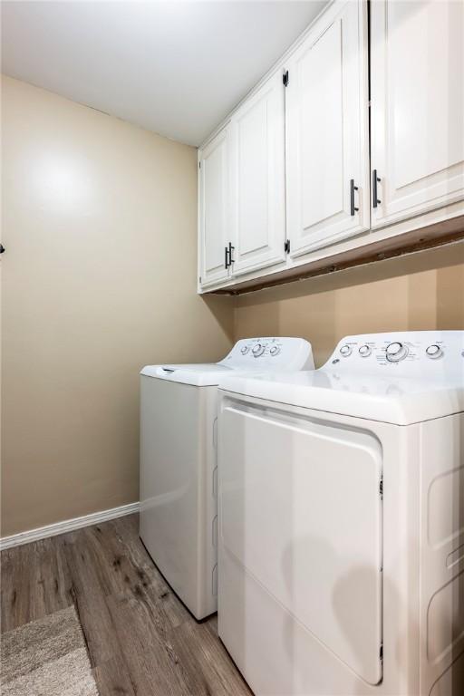 1801 Jean St, Springdale, AR 72762 - laundry area featuring cabinet space, washing machine and dryer, and light wood finished floors