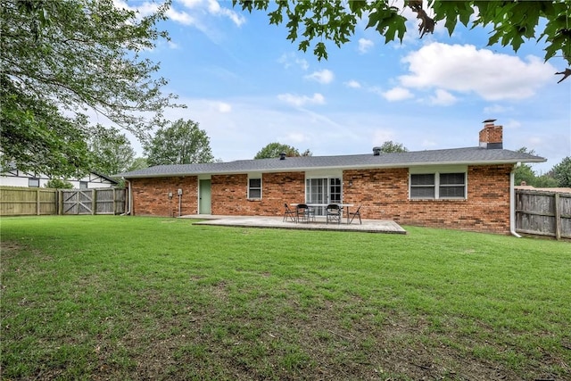 1801 Jean St, Springdale, AR 72762 - back of property with a patio, brick siding, a fenced backyard, and a chimney