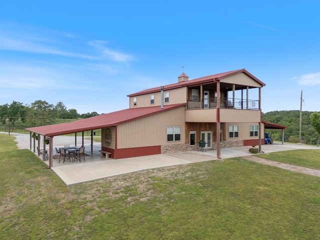 713 Madison Unit 8744, Huntsville, AR 72740 - rear view of house with a patio area, a lawn, stone siding, and a balcony