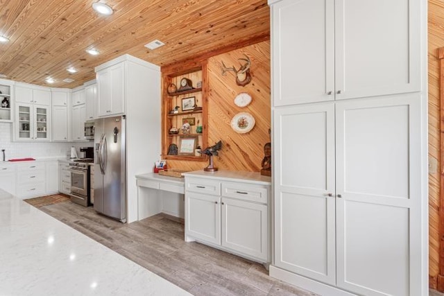 713 Madison Unit 8744, Huntsville, AR 72740 - kitchen featuring appliances with stainless steel finishes, white cabinetry, wood ceiling, glass insert cabinets, and light stone counters