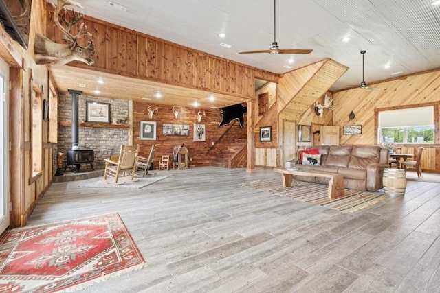 713 Madison Unit 8744, Huntsville, AR 72740 - living room with wooden walls, a wood stove, ceiling fan, wood finished floors, and recessed lighting