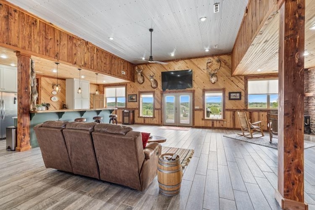 713 Madison Unit 8744, Huntsville, AR 72740 - living area with wooden walls, wood finished floors, and a ceiling fan