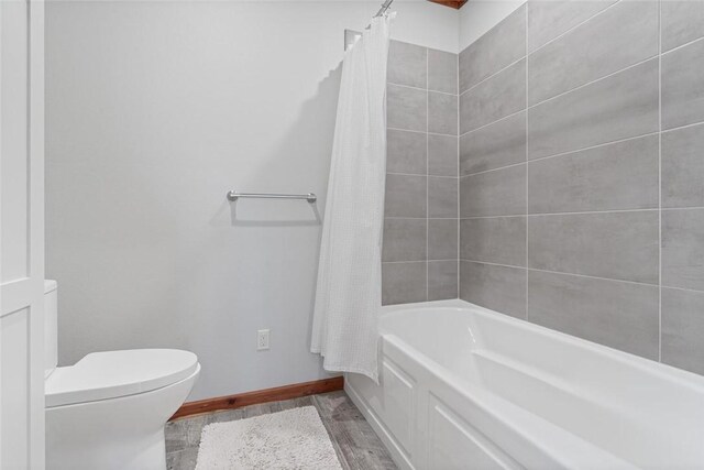 713 Madison Unit 8744, Huntsville, AR 72740 - full bath with wood finished floors, baseboards, toilet, and shower / bath combo