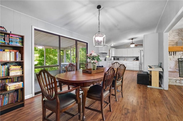 1 Morris Ln, Bella Vista, AR 72715 - dining area featuring wood finished floors, a ceiling fan, a stone fireplace, a chandelier, and lofted ceiling