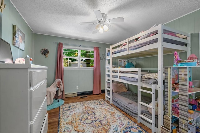 1 Morris Ln, Bella Vista, AR 72715 - bedroom featuring wood finished floors, a textured ceiling, a baseboard radiator, and ceiling fan