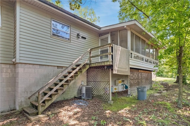 1 Morris Ln, Bella Vista, AR 72715 - back of property featuring stairway, a sunroom, and central AC
