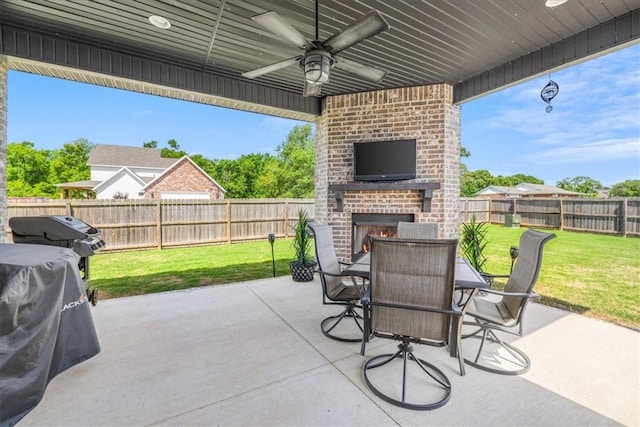 view of patio with an outdoor brick fireplace, ceiling fan, and outdoor dining space