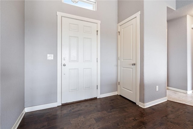 entryway with wood finished floors and baseboards