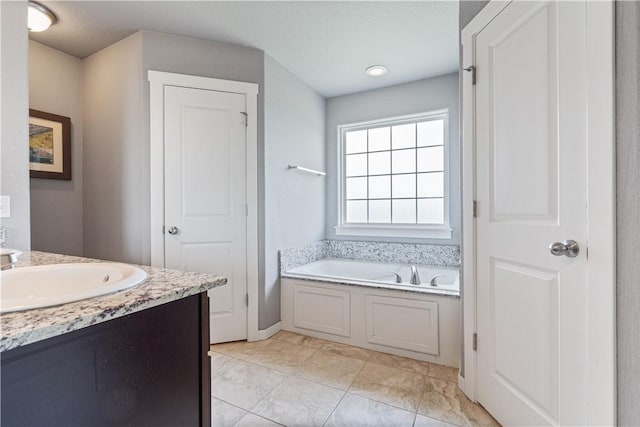 full bath with a garden tub and vanity
