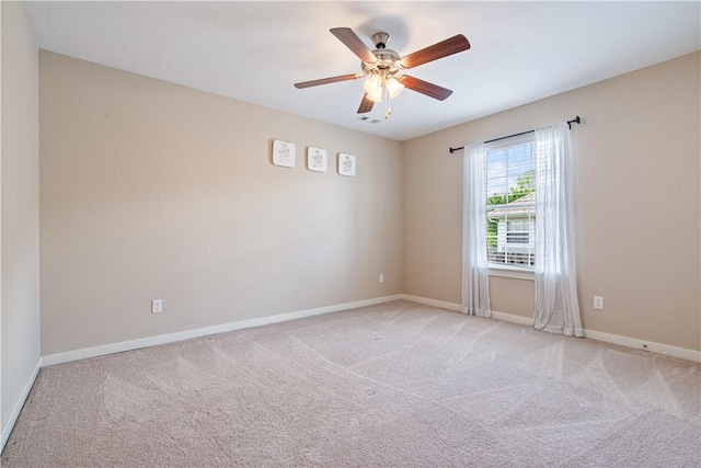 unfurnished room featuring light carpet, ceiling fan, and baseboards